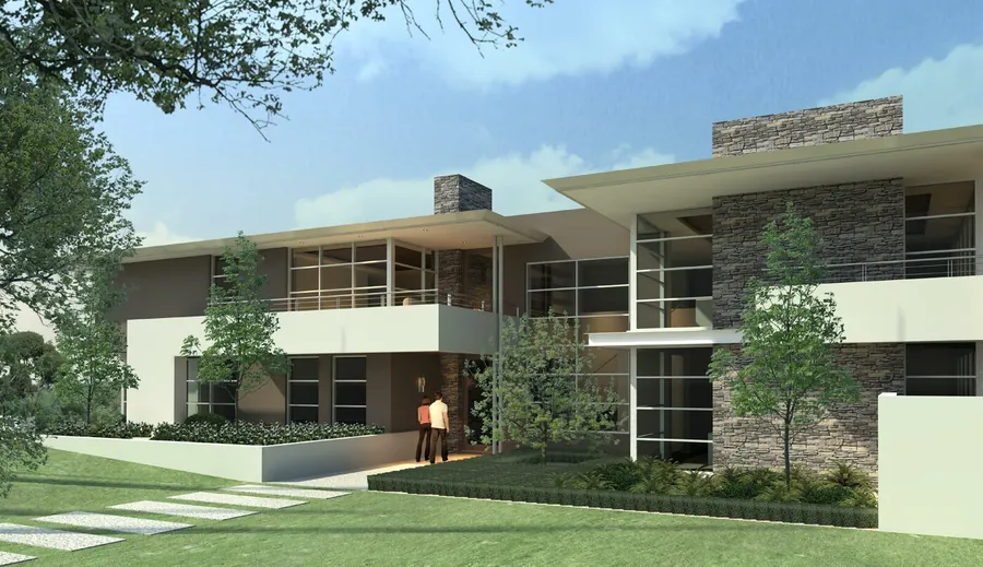 Front entry of the home — stone-clad feature columns, cantilevered upper level, recessed entrance.